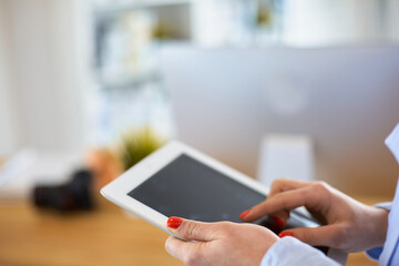 Portrait of an attractive professional photographer woman and using a tablet