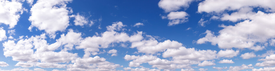 Naklejka na ściany i meble Clouds in blue sky. White, fluffy clouds In blue sky. Background nature. Texture cumulus floating on blue sky. Backgrounds concept. Environment, atmosphere. Place for an inscription or logo