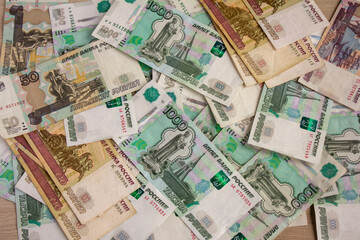Money, Russian banknotes of various denominations are scattered on the table.