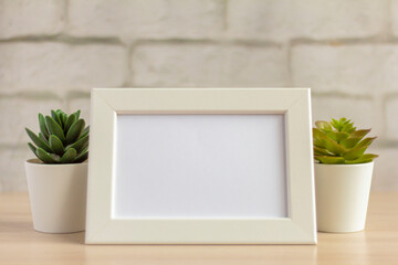 An empty photo frame on a table or shelf with a copy of the space