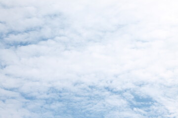 Summer sky filled with white wispy clouds with very little blue showing through