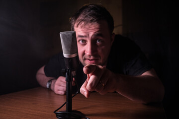 Serious reporter in television studio looking at the camera