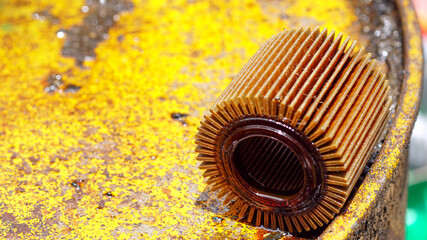 Filter used engine oil on a yellow oil tank.