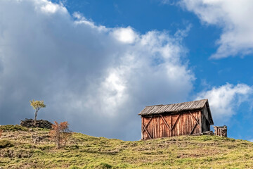 Small wooden ranch on top of a hill