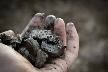 dramatic hand with coal 