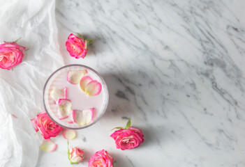 Fototapeta na wymiar Moon milk prepares with pink rose flower. Trendy relaxing bedtime drink form Ayurvedic traditions