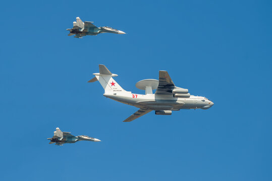 ST. PETERSBURG, RUSSIA - JULY 25, 2019: A-50 Liska aircraft (RF-93966), accompanied by two Su-30SM multi-role fighters 