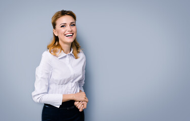 Very happy smiling attractive businesswoman, with copy space area for some slogan or text....