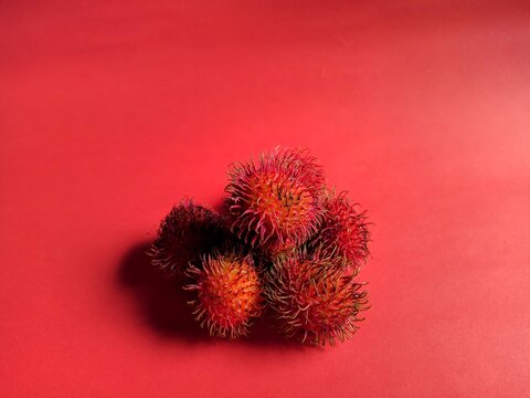 Close-up of rambutan fruit with red background. exotic fruits from Asia