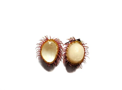 Rambutan fruit cut in half with white background. exotic fruits from Asia