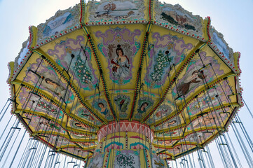 Empty big swings at a carnival express the concept of cancelled or closed fairgrounds during the pandemic.