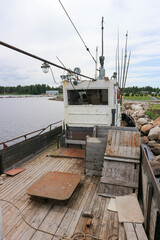 on the deck of a old abandoned fishing boat stuck in the stones