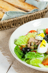 Chef's salad with tuna fish, black olives and egg in caper-mayonaisse sauce.