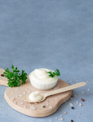 Mayonnaise swirl bowl next to wooden spoon with mayo