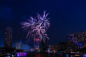Beautiful firework display for celebration happy new year and merry christmas with  Twilight night and firework lighting in bangkok cityscape background, Thailand.