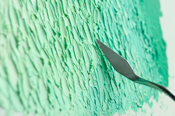 Abstract colorful artwork painting with spatula, closeup view
