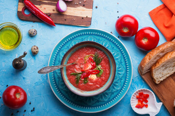  classic spanish raw eating cold soup Gazpacho served at blue  table. flat lay. food recipe. healthy concept.