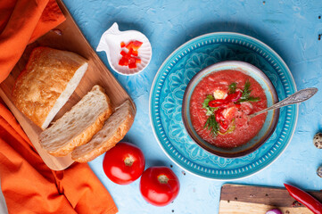  classic spanish raw eating cold soup Gazpacho served at blue  table. flat lay. food recipe. healthy concept.