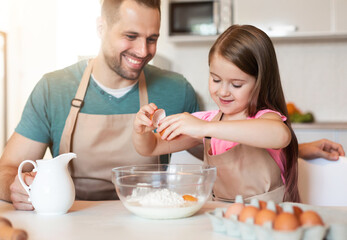 Dad And Daughter Making Dough Baking Cookies Together At Home