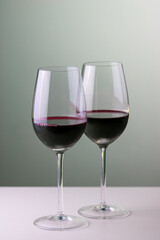 Sharing a bottle of red wine with two glasses