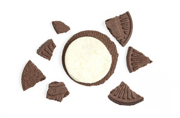 Sandwich cookie in pieces. Tea biscuit filled with milk cream crushed on white background.