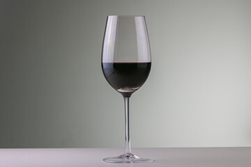 Glass of red wine in neutral background