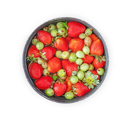 Isolated bowl with berries. The berry-picking season, the harvest. Fresh natural strawberries and gooseberries in a bowl with water on white background. The concept of organic, healthy seasonal fruits