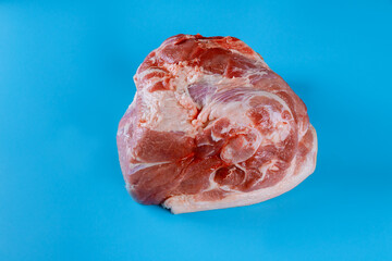 Raw pork leg isolated on blue background