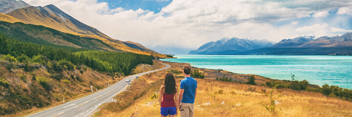 New Zealand travel people looking at Mount Cook Aoraki far in the landscape. Couple tourists...