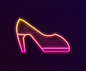 Glowing neon line Woman shoe with high heel icon isolated on black background. Vector.