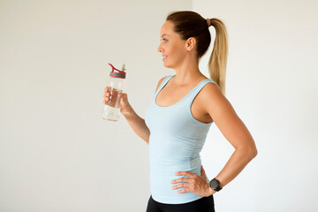 beautiful woman in sportswear with a bottle of water