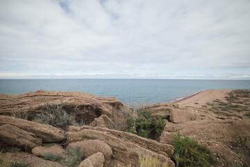 Beautiful mountain landscape. The shore of Lake Issyk-Kul. Wildlife of Kyrgyzstan. Clouds in the sky.