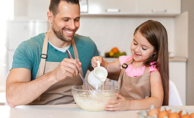 Little Girl Baking With Daddy Making Dough Together At Home