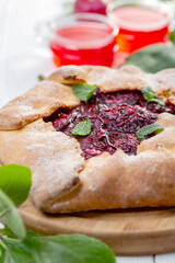 Sweet open pie with red plums.
