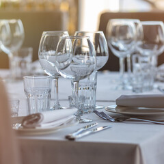 Empty glasses in restaurant background. Table set for an event party or wedding reception.