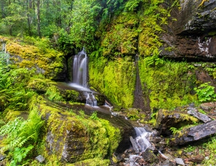 Fototapeta na wymiar Rippling waterfall over granite rocks