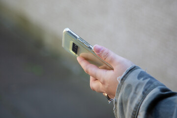 a womans hand holding a mobile phone or cell phone