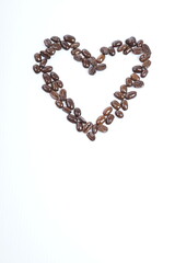 Roasted coffee beans in shape of hart on white background