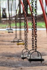 The swings are children's toys located in the park.