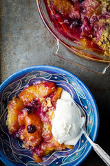 Peach and blueberry crumble with vanilla ice cream