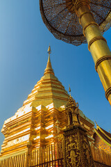 Beautiful northern Thai style architectural of golden pagoda with golden umbrella at Wat Phra That Doi Suthep, the famous temple and became the landmark of Chiang Mai, Thailand.