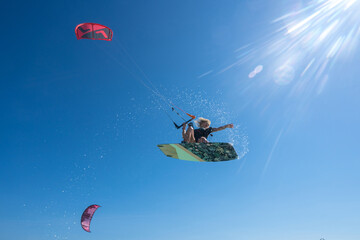 Kite girl rides in the ocean clear water