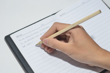 Hand Writing in The Notebook with Isolated White Background