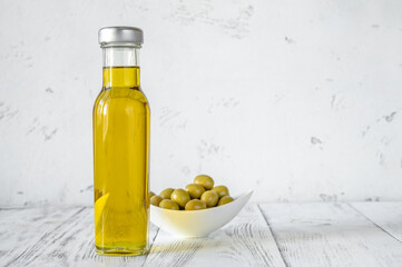Bottle of olive oil with green olives