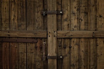 Stare drewniane drzwi od stodoły, brożowe, zamek, kłódka.