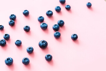Colorful fruit pattern of blueberries on pink background. Top view. Flat lay