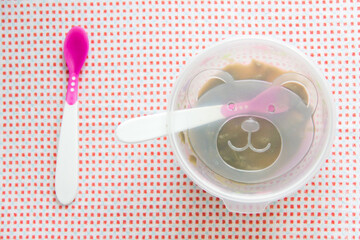 Baby accessories on pink pattern background on table