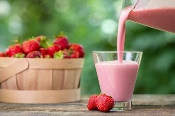 strawberry milkshake pouring in glass