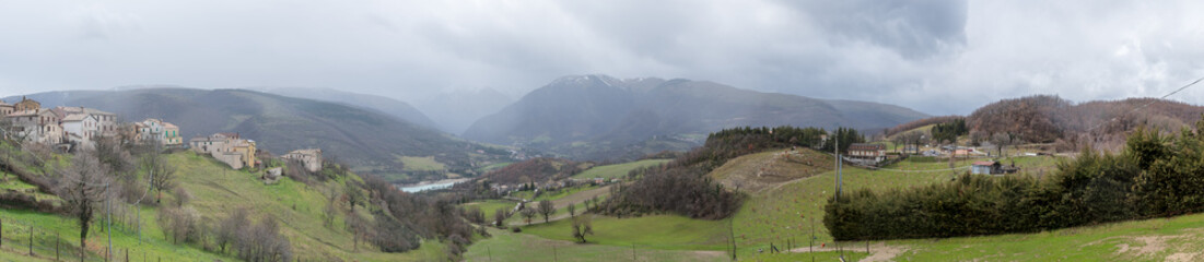 Landscape of green fields with mountains in the background and blue skies in the province of...