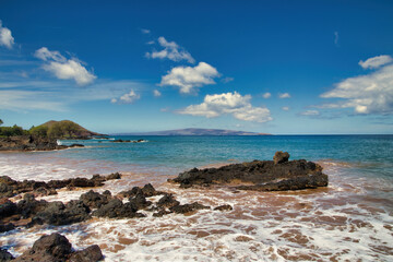 Scenic view of ocean, beach and Kahoolawe island in the distance from Secret Beach on Maui.